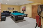 The games room has it all including a pool table, near the back are two twin beds, perfect for kids and teens